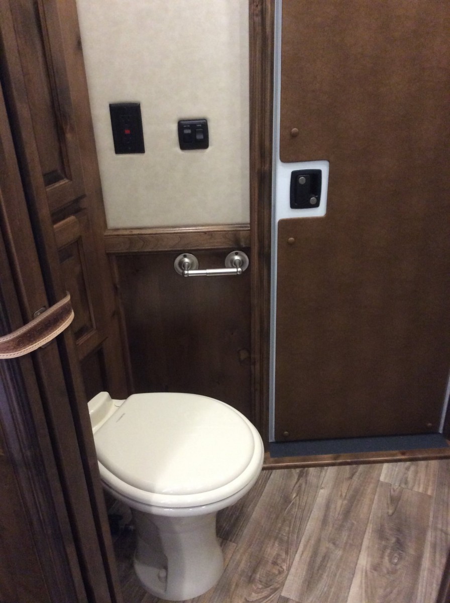 A toilet inside of a horse trailer