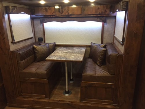 Convertible dinette area inside of a Double D Trailer living quarters model. 