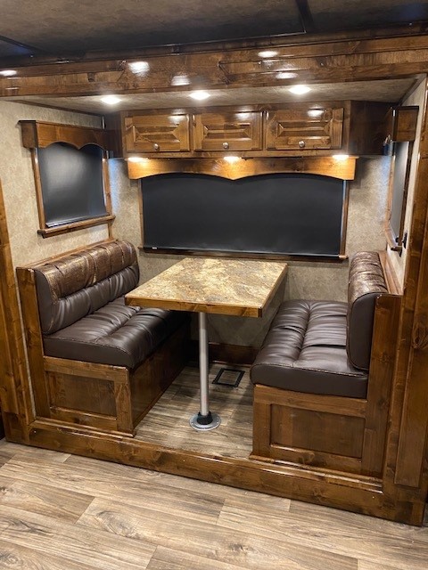 A convertible dinette sofa inside of a Double D Trailers living quarters horse trailer. 