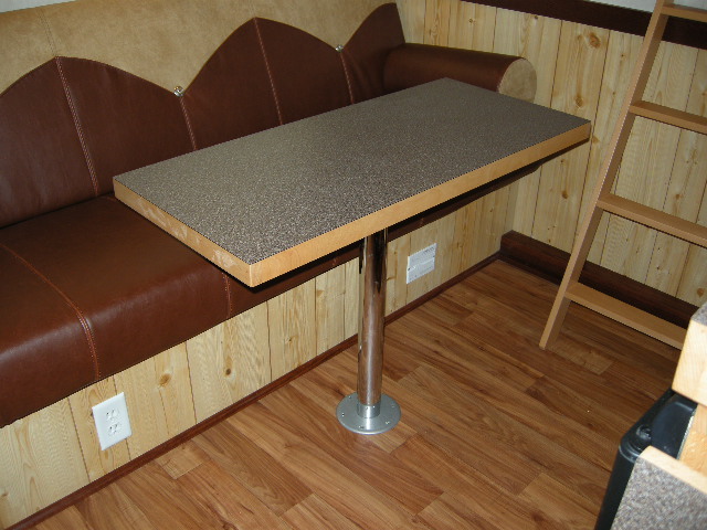 Removable pedestal table inside of a living quarters horse trailer. 
