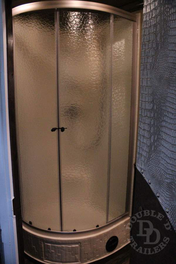 A rounded shower stall on a Double D Trailers living quarters horse trailer model