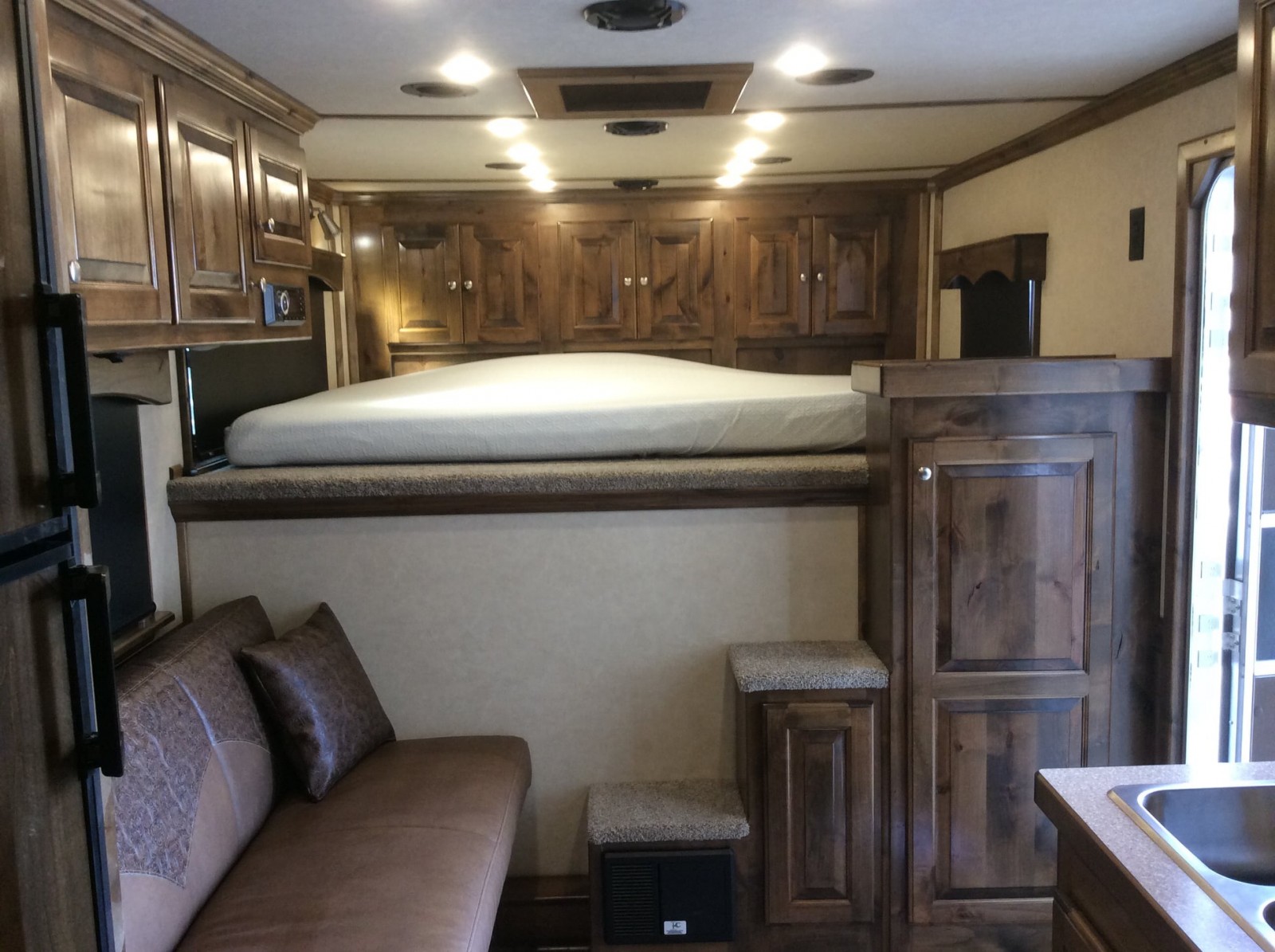 A bed inside of a Double D Trailers living quarters horse trailer. 