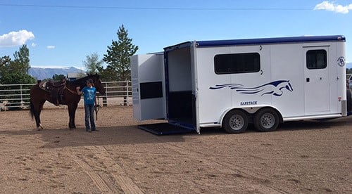 A Double D Trailer owner posing with horse trailer 