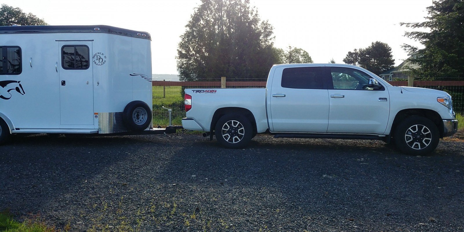 white tundra truck towing a bumper pull horse trailer