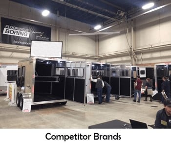 Horse trailers displayed side by side at a horse trailer exhibit. 