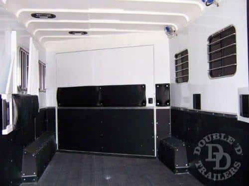 Interior of a Double D trailer showing white upper finish and one-piece fiber composite roof, and black rubber Safekick wall covering. 