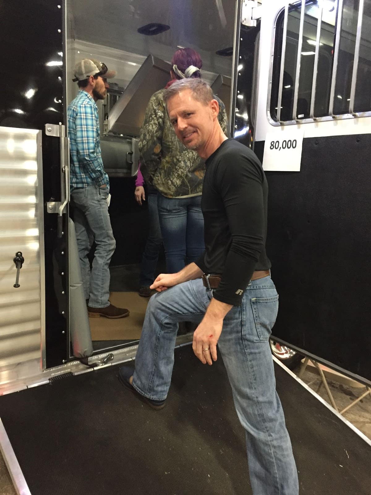 D. Brad Heath stepping on a very steep side ramp of a horse trailer.