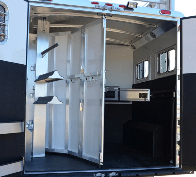 Traditional reverse slant horse trailer designs have a stationary tack compartment that limits open space in the trailer.