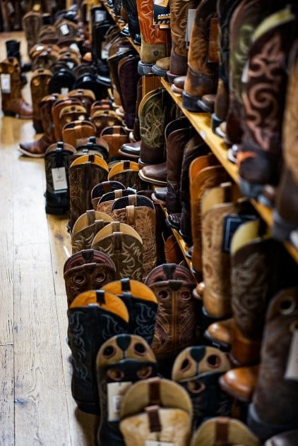 a wide variety of cowboy boot brands display in a store