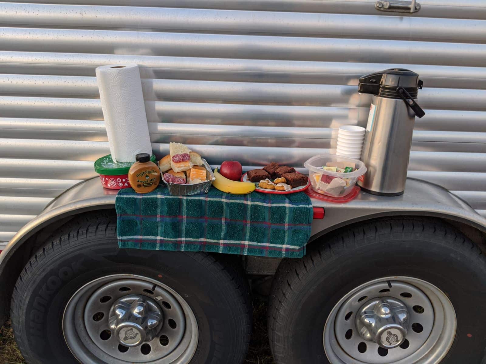 Fender feasting: Using a horse trailer wheel cover as a table for eating.