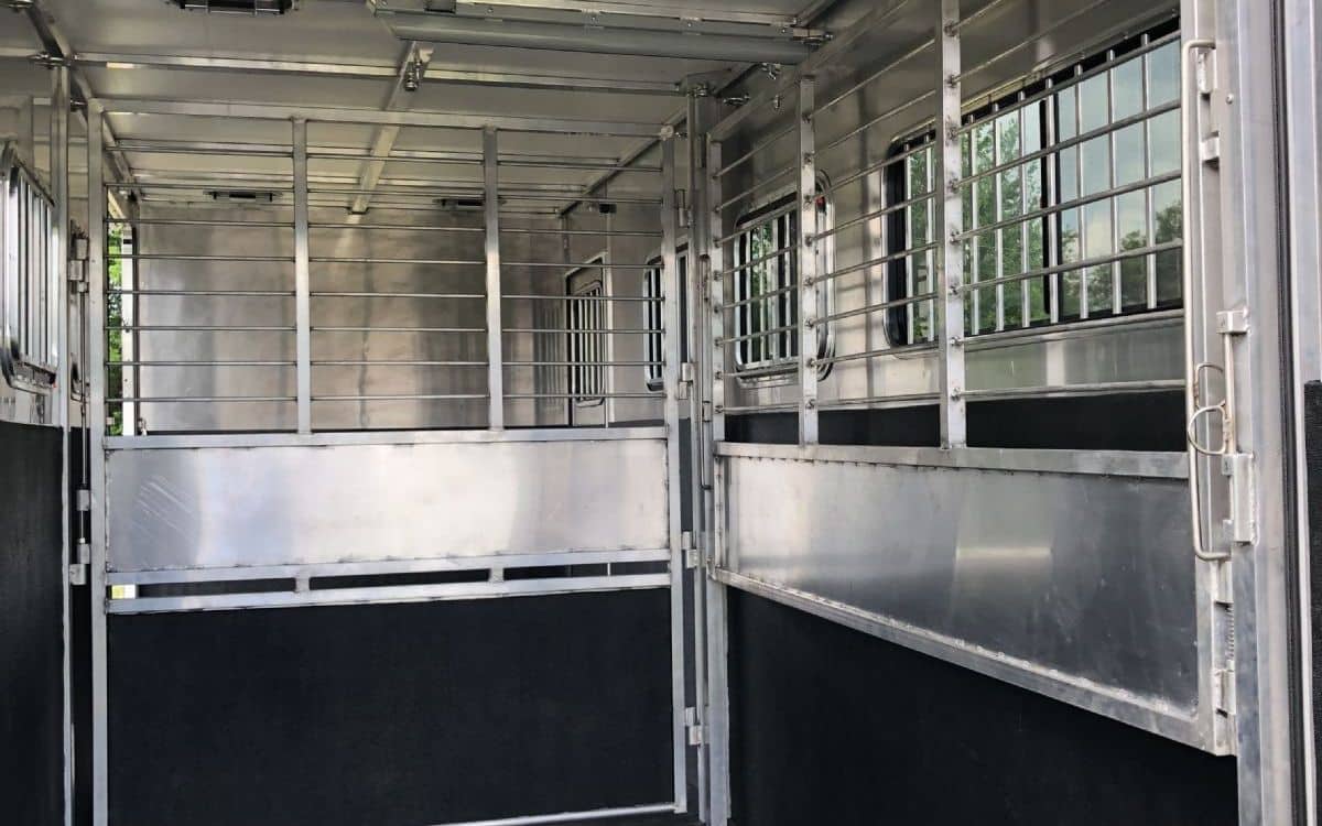 Standard horse trailer dividers are heavy, bulky, and immovable.