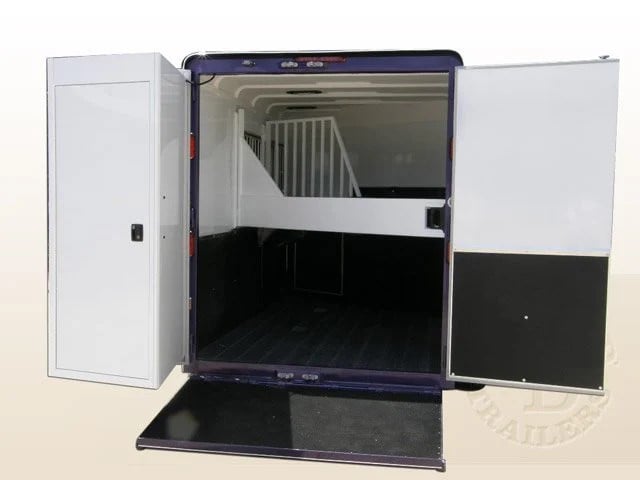 A Double D Trailers horse trailer displaying the rear ramp entryway with the SafeTack compartment swung open.