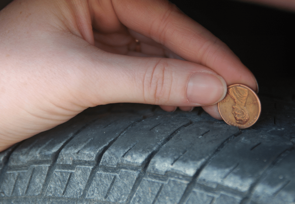 Using a penny to check the tread of a tire. 