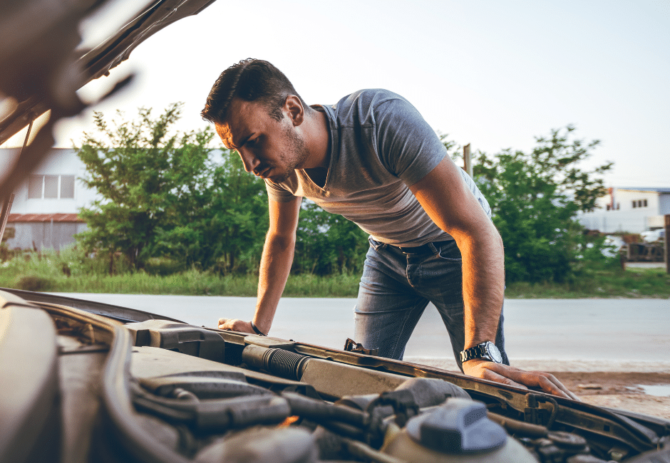 A man checking under the hood of his tow vehicle. 