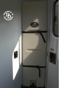 Double D bumper pull horse trailer interior equipped with an upright water tank.
