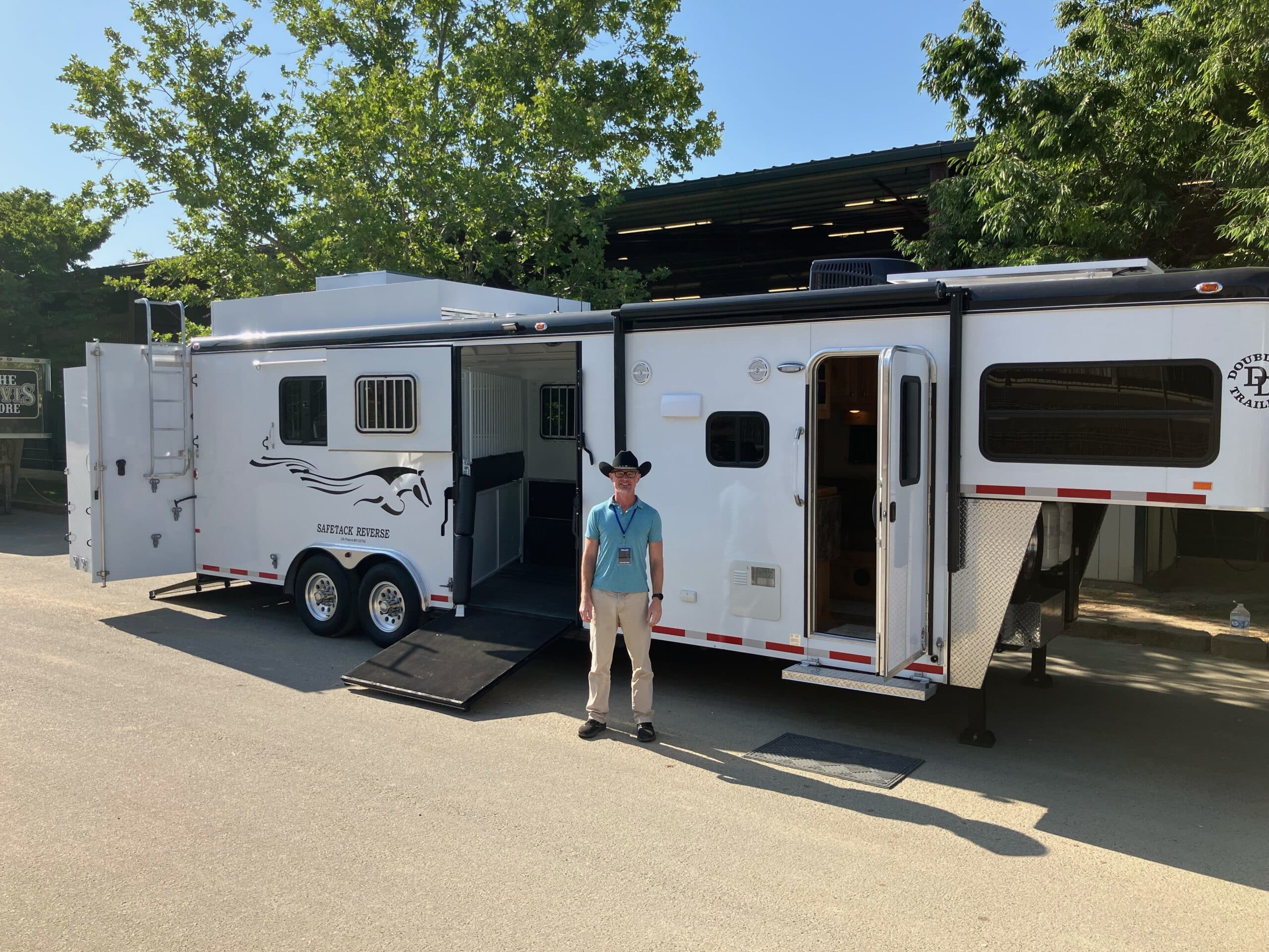 Double D Trailers owner Brad Heath beside a SafeTack Reverse horse trailer at the Western States Horse Expo.